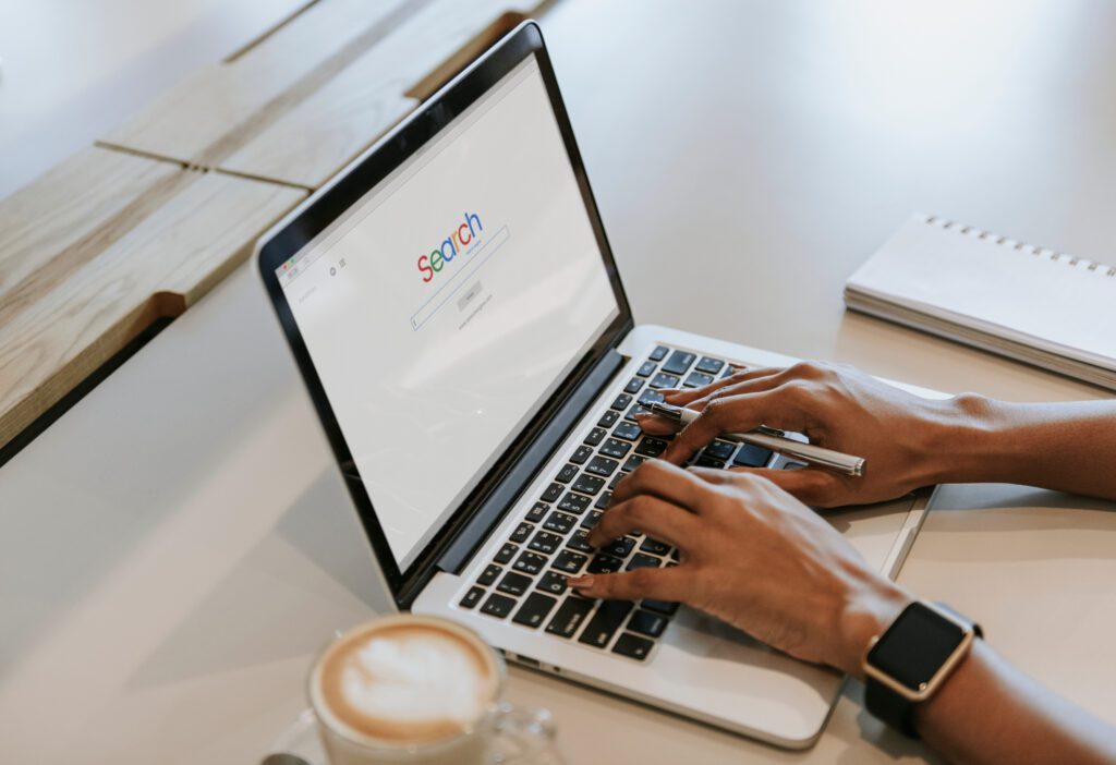 Person doing an online search from laptop for information