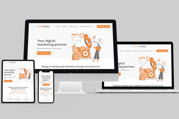 Four devices (desktop, laptop, tablet, and smartphone) display the same website for Vivid Image, a digital marketing partner, featuring orange and white colors and an illustration of people with digital marketing icons.